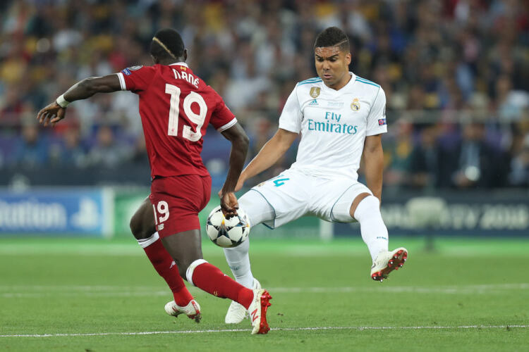 Casemiro of Real Madrid tackles Sadio Mane of Liverpool