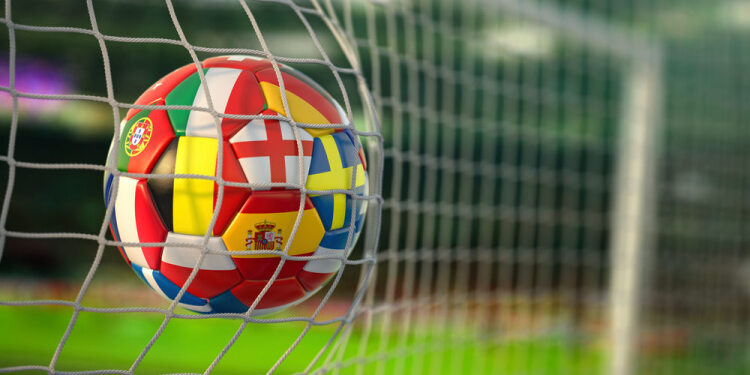 National flags on a football in a goal