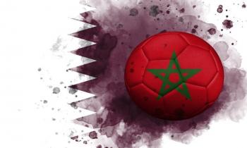 Football with the flag of Morocco on a background of the flag of Qatar