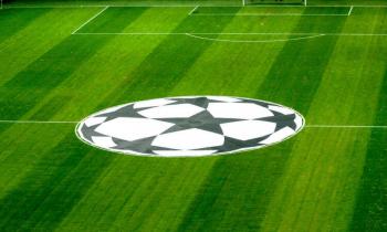 Champions League logo on San Siro pitch