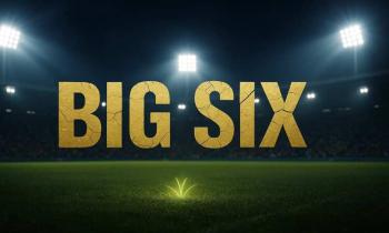 Cracked golden “BIG SIX” sign in a floodlit football stadium.